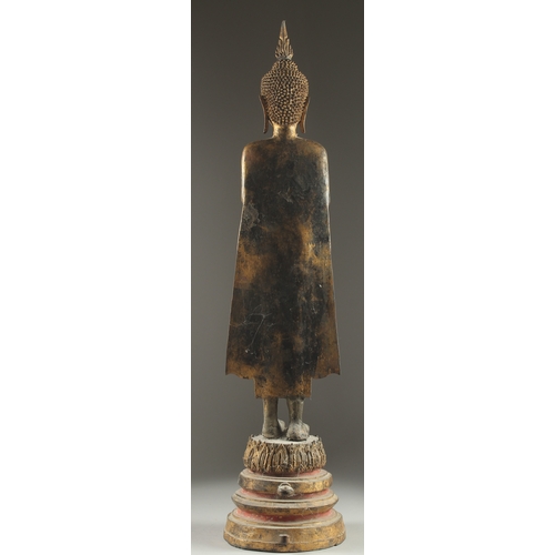 159 - A FINE AND LARGE 19TH CENTURY OR EARLIER THAI GILDED BRONZE BUDDHA, stood upon a graduating circular... 