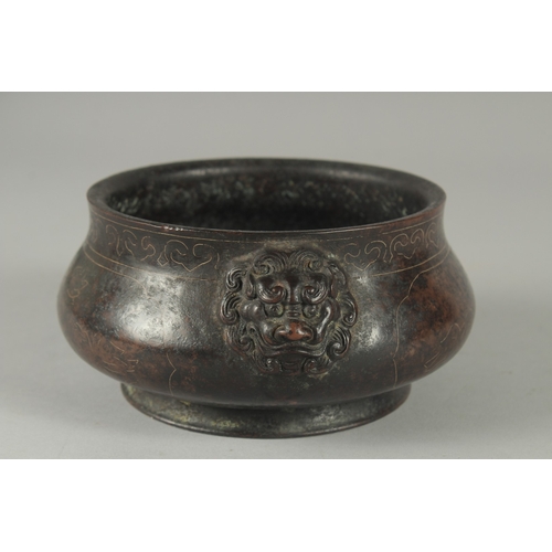 161 - A 19TH / 20TH CENTURY CHINESE WIRE INLAID HEAVY BRONZE CENSER, with relief lion head handles, 17cm w... 