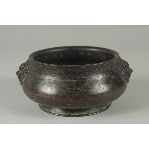 161 - A 19TH / 20TH CENTURY CHINESE WIRE INLAID HEAVY BRONZE CENSER, with relief lion head handles, 17cm w... 