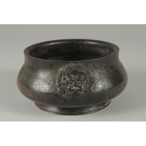 161 - A 19TH / 20TH CENTURY CHINESE WIRE INLAID HEAVY BRONZE CENSER, with relief lion head handles, 17cm w... 