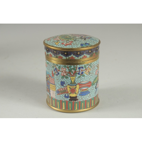 166 - A CHINESE BLUE GROUND CLOISONNE CYLINDRICAL BOX AND COVER, decorated with various objects, the base ... 