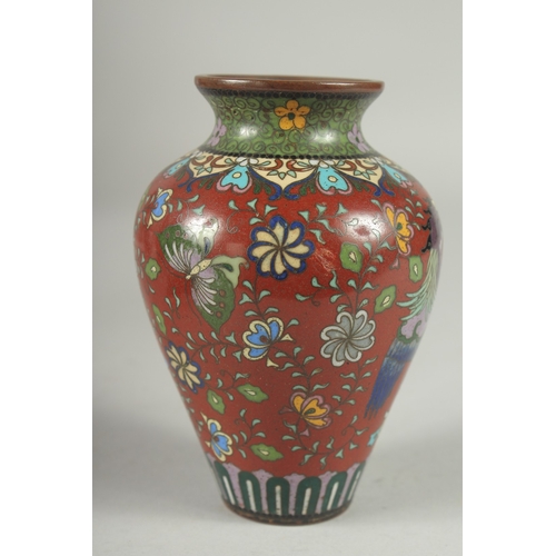 168 - A CHINESE RED GROUND CLOISONNE PHOENIX VASE, with butterflies and various floral motifs, 12.5cm high... 