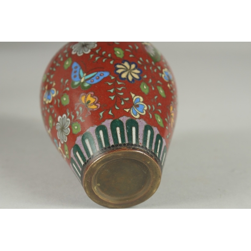 168 - A CHINESE RED GROUND CLOISONNE PHOENIX VASE, with butterflies and various floral motifs, 12.5cm high... 