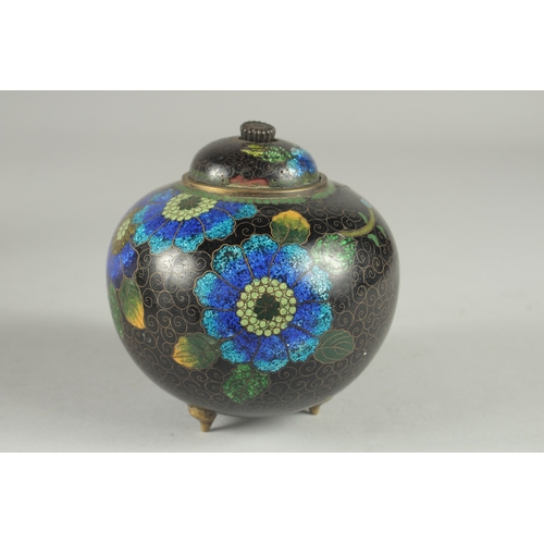 169 - A CHINESE BLACK GROUND CLOISONNE JAR AND COVER, with glittered enamel flowers, 11cm high.