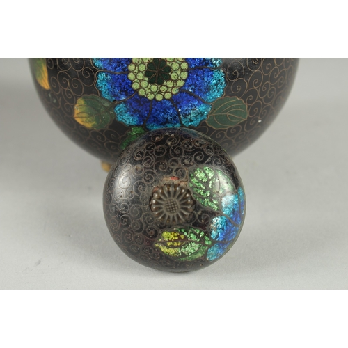 169 - A CHINESE BLACK GROUND CLOISONNE JAR AND COVER, with glittered enamel flowers, 11cm high.