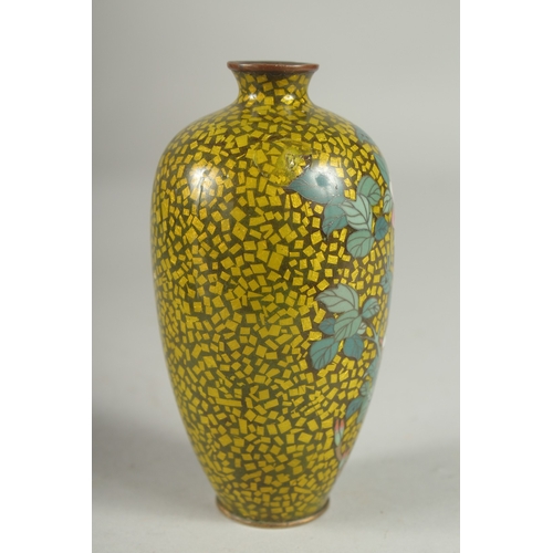 171 - A JAPANESE YELLOW GROUND GLITTERED ENAMEL CLOISONNE VASE, decorated with a flower, with character ma... 