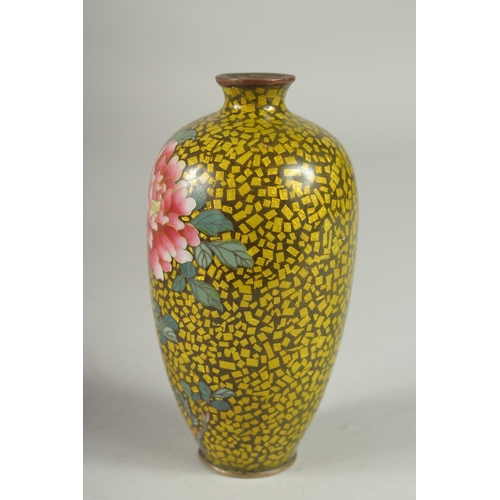 171 - A JAPANESE YELLOW GROUND GLITTERED ENAMEL CLOISONNE VASE, decorated with a flower, with character ma... 