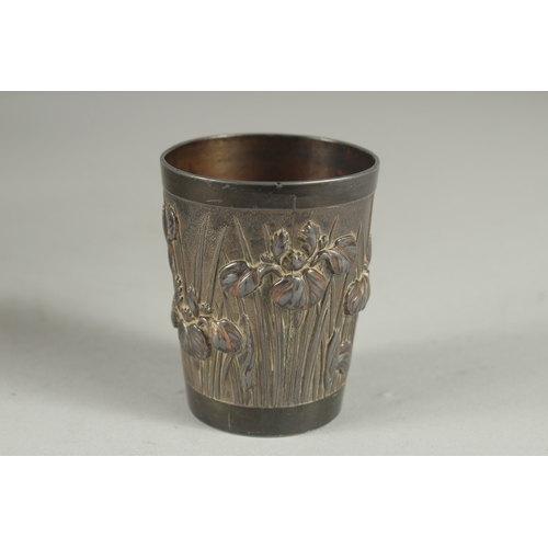 178 - A CHINESE METAL BEAKER, relief decorated with flora, 6cm high.