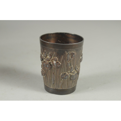 178 - A CHINESE METAL BEAKER, relief decorated with flora, 6cm high.