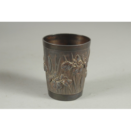 178 - A CHINESE METAL BEAKER, relief decorated with flora, 6cm high.