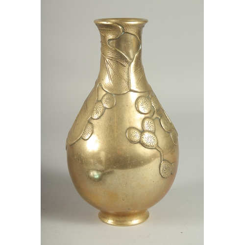 180 - A JAPANESE BRASS JUG, with relief foliate decoration, 23cm high.