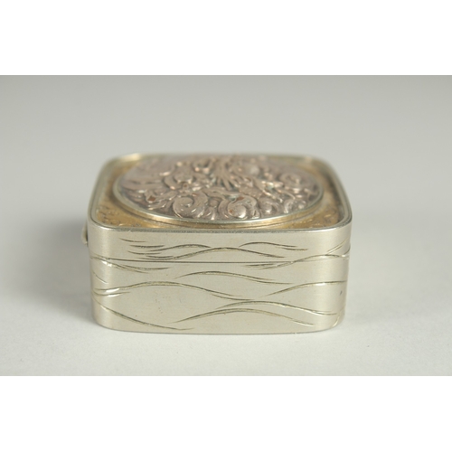 181 - A SMALL SIGNED JAPANESE WHITE METAL AND BRASS BOX, the hinged lid with relief dragon roundel, 5cm sq... 