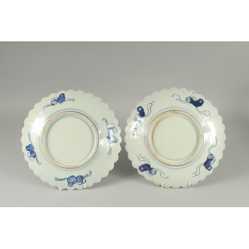 193 - A PAIR OF JAPANESE BLUE AND WHITE PORCELAIN PETAL-FORM PLATES, 31cm wide.