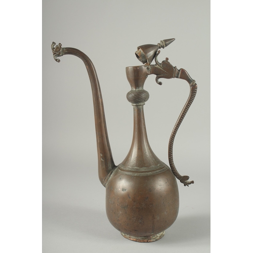 219 - AN 18TH CENTURY PERSIAN SAFAVID COPPER EWER, the handle and spout with dragon head terminals, 38cm h... 