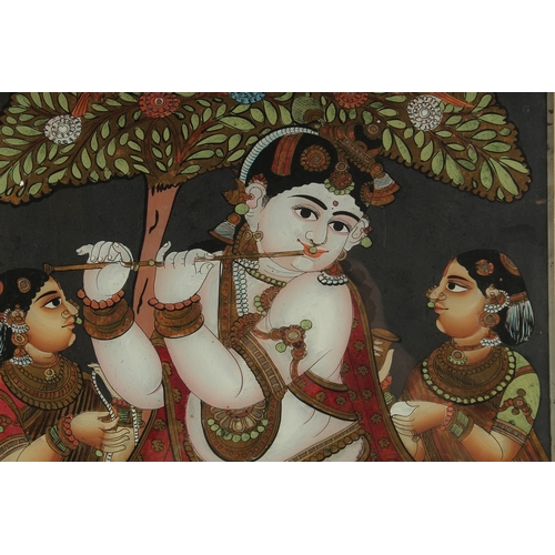 233 - A FINE AND LARGE SOUTH INDIAN TANJORE REVERSE GLASS PAINTING OF FLUTING KRISHNA, inset within a wood... 