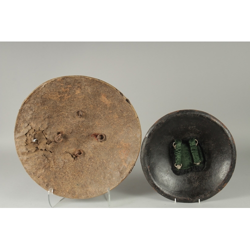 236 - TWO INDIAN SHIELDS, (af), 46cm wide and 34.5cm diameter, (2).