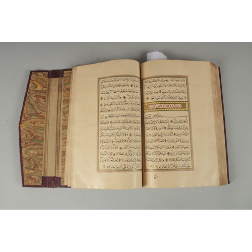 240 - AN 18TH CENTURY OTTOMAN LEATHER BOUND ILLUMINATED QURAN, the manuscript written in naskh in black in... 