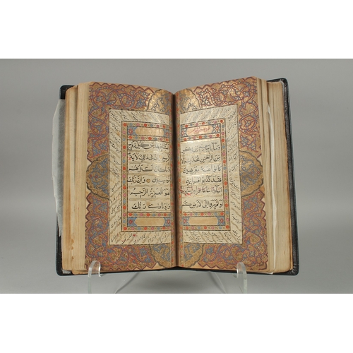 241 - A 19TH CENTURY NORTH INDIAN KASHMIR LEATHER BOUND ILLUMINATED QURAN, the manuscript written in naskh... 