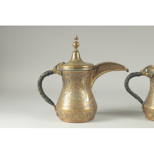 250 - THREE EYGPTIAN CAIROWARE SILVER AND COPPER INLAID BRASS COFFEE POTS, of graduating sizes, each inscr... 