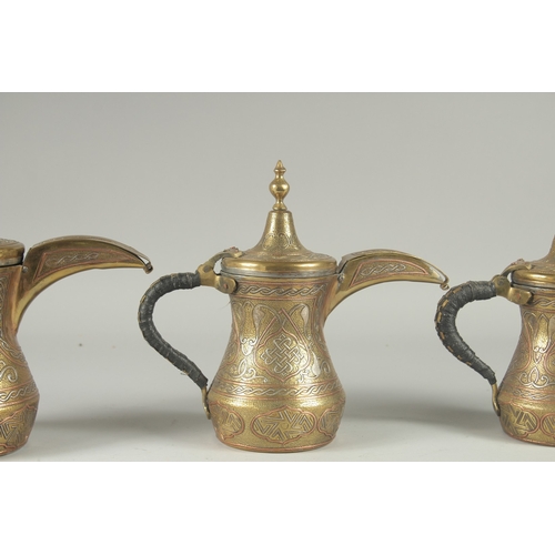 250 - THREE EYGPTIAN CAIROWARE SILVER AND COPPER INLAID BRASS COFFEE POTS, of graduating sizes, each inscr... 