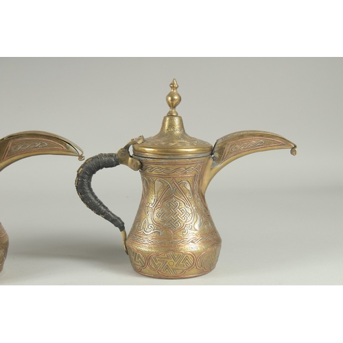 250 - THREE EYGPTIAN CAIROWARE SILVER AND COPPER INLAID BRASS COFFEE POTS, of graduating sizes, each inscr... 