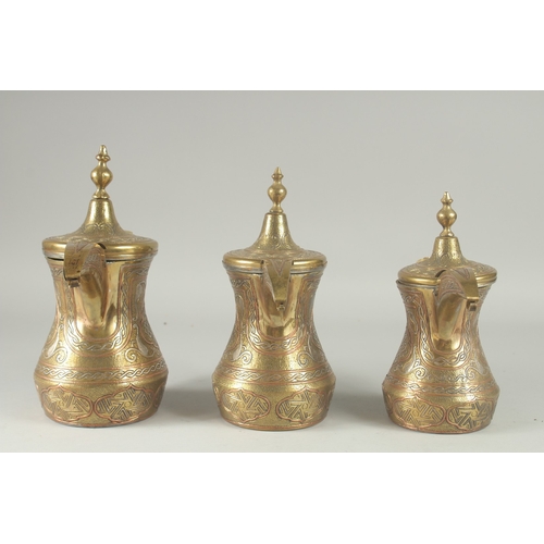 250 - THREE EYGPTIAN CAIROWARE SILVER AND COPPER INLAID BRASS COFFEE POTS, of graduating sizes, each inscr... 