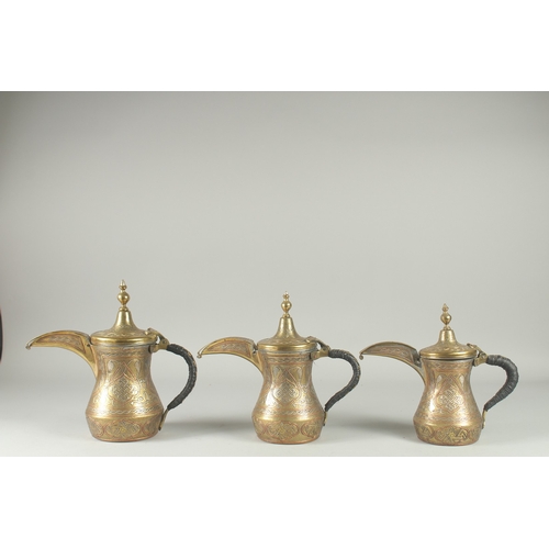 250 - THREE EYGPTIAN CAIROWARE SILVER AND COPPER INLAID BRASS COFFEE POTS, of graduating sizes, each inscr... 