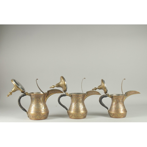 250 - THREE EYGPTIAN CAIROWARE SILVER AND COPPER INLAID BRASS COFFEE POTS, of graduating sizes, each inscr... 