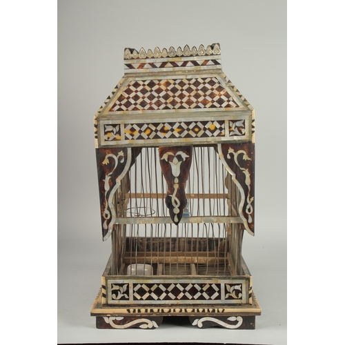 251 - AN EARLY 20TH CENTURY MOTHER OF PEARL AND TORTOISESHELL INLAID BIRD CAGE, 49cm high. 252.