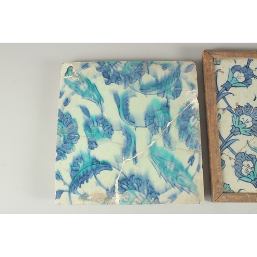 264 - TWO EARLY 17TH CENTURY OTTOMAN IZNIK BLUE AND WHITE GLAZED POTTERY TILES, each approx. 25cm square (... 