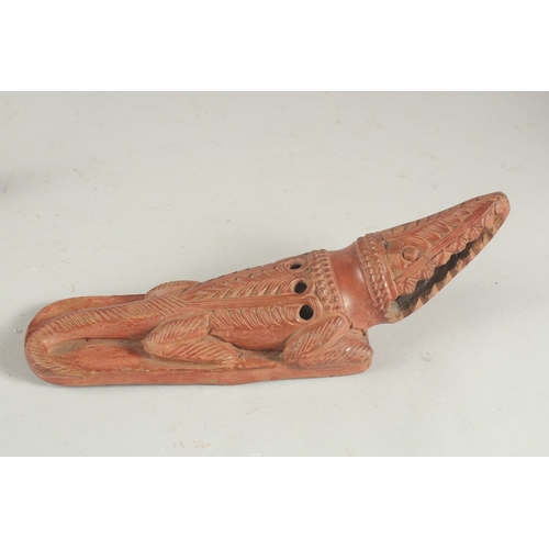 272 - TWO LATE 19TH CENTURY OTTOMAN TURKISH OR EYGPTION RED CLAY FOOT SCRAPERS formed as crocodiles, 22cm ... 