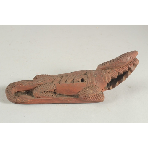 272 - TWO LATE 19TH CENTURY OTTOMAN TURKISH OR EYGPTION RED CLAY FOOT SCRAPERS formed as crocodiles, 22cm ... 