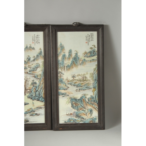 40 - FOUR CHINESE FAMILLE VERTE PORCELAIN PANELS, inset within wooden frames, each depicting mountainous ... 