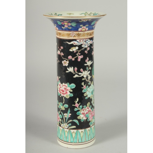 44 - A FAMILLE NOIR PORCELAIN CYLINDRICAL VASE, painted with peacocks and flora, mark to base, 26cm high.