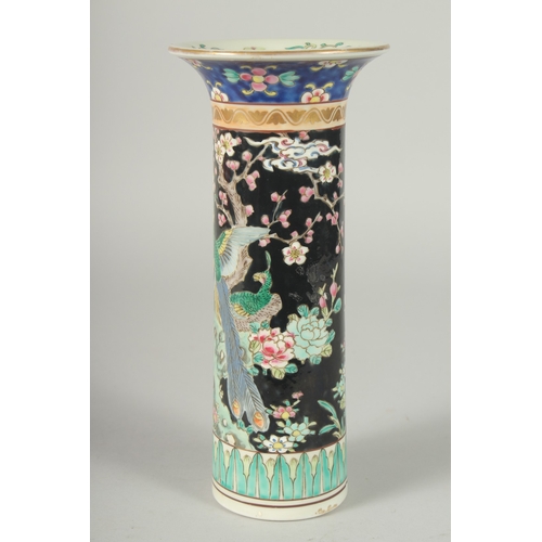 44 - A FAMILLE NOIR PORCELAIN CYLINDRICAL VASE, painted with peacocks and flora, mark to base, 26cm high.