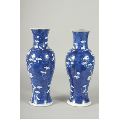 45 - A PAIR OF CHINESE BLUE AND WHITE PORCELAIN PRUNUS BALUSTER VASES, 30cm high.