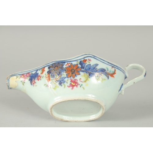 48 - A FAMILLE ROSE PORCELAIN SAUCE BOAT, with gilt highlights, (af), 21cm long.