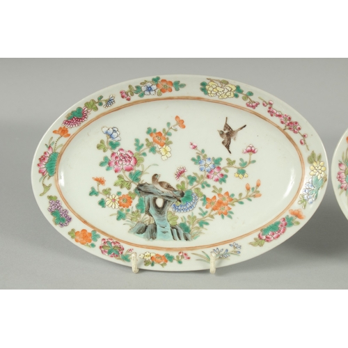 50 - A PAIR OF CHINESE FAMILLE ROSE PORCELAIN OVAL DISHES, painted with birds and flora, each with red si... 