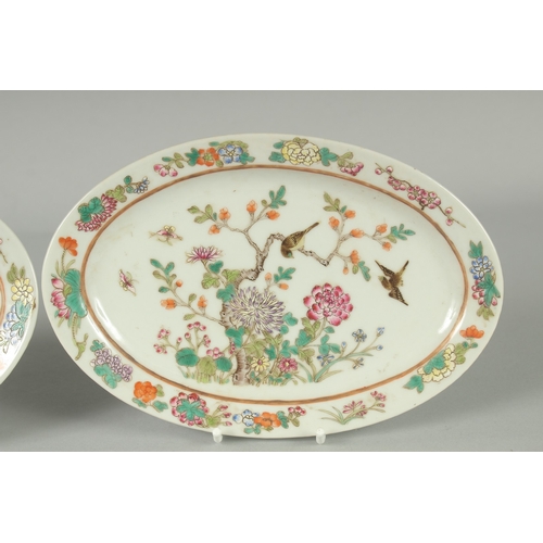 50 - A PAIR OF CHINESE FAMILLE ROSE PORCELAIN OVAL DISHES, painted with birds and flora, each with red si... 