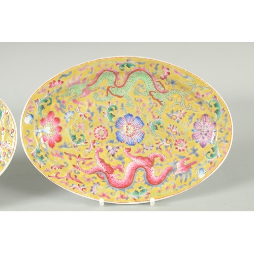 51 - A PAIR OF CHINESE YELLOW GROUND FAMILLE ROSE PORCELAIN OVAL DISHES, painted with dragon and flora, e... 