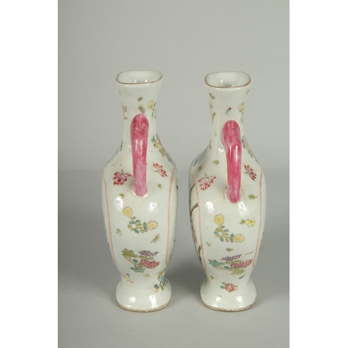 52 - A PAIR OF CHINESE FAMILLE ROSE PORCELAIN TWIN HANDLE VASES, painted with birds and flora, each base ... 