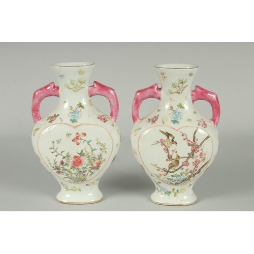 52 - A PAIR OF CHINESE FAMILLE ROSE PORCELAIN TWIN HANDLE VASES, painted with birds and flora, each base ... 