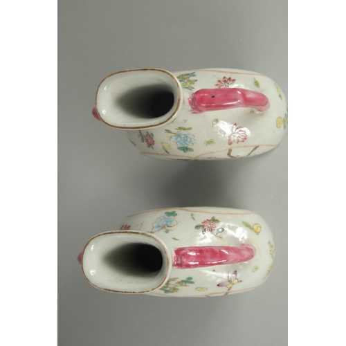 52 - A PAIR OF CHINESE FAMILLE ROSE PORCELAIN TWIN HANDLE VASES, painted with birds and flora, each base ... 