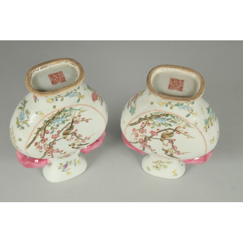 52 - A PAIR OF CHINESE FAMILLE ROSE PORCELAIN TWIN HANDLE VASES, painted with birds and flora, each base ... 