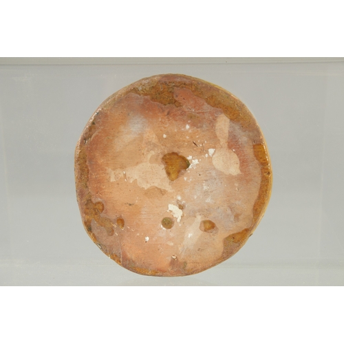 570 - AN ISLAMIC GLAZED POTTERY CIRCULAR PLAQUE, 10cm diameter.