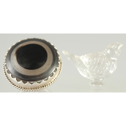 573 - AN ISLAMIC GLASS BIRD, together with a large ring (2).