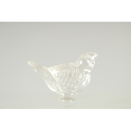 573 - AN ISLAMIC GLASS BIRD, together with a large ring (2).