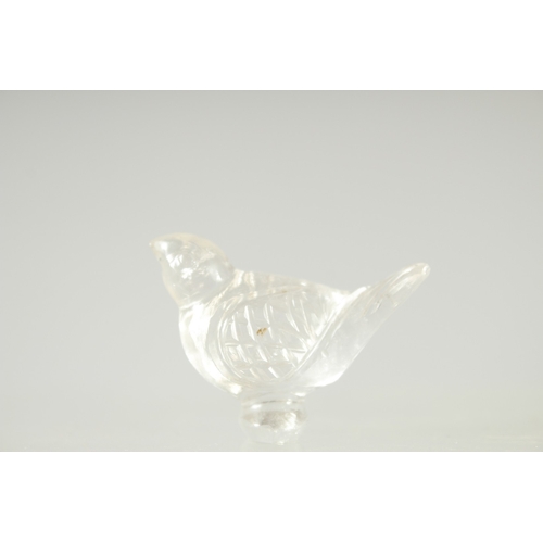 573 - AN ISLAMIC GLASS BIRD, together with a large ring (2).