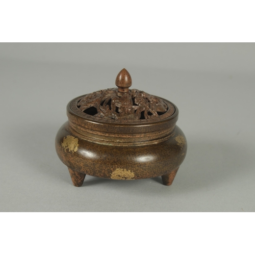 58 - A CHINESE BRONZE GOLD SPLASH CENSER AND OPENWORK COVER, on tripod legs with character mark to base, ... 