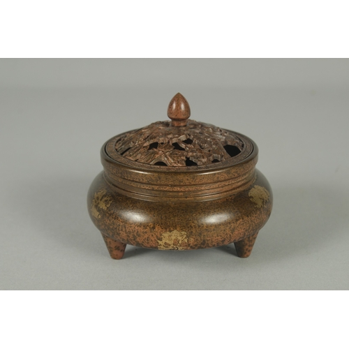 58 - A CHINESE BRONZE GOLD SPLASH CENSER AND OPENWORK COVER, on tripod legs with character mark to base, ... 